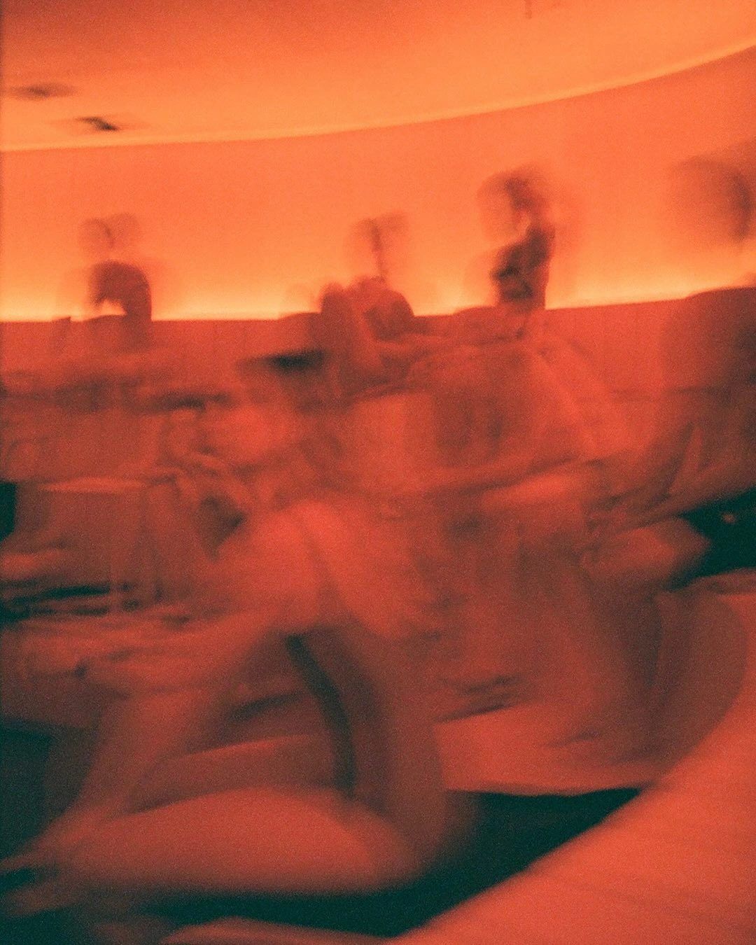 People in a sauna in warm orange light